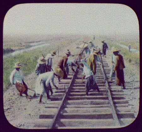 Workmen repairing railroad track